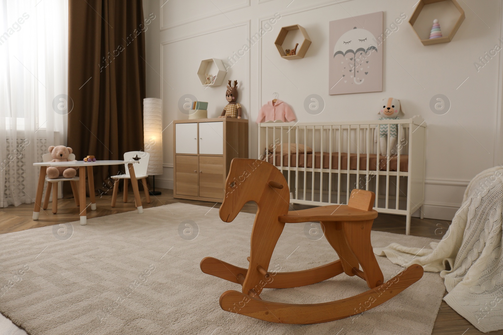 Photo of Modern baby room interior with stylish furniture and toys