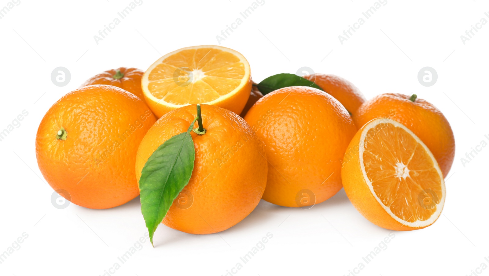 Photo of Cut and whole fresh ripe oranges with green leaves on white background