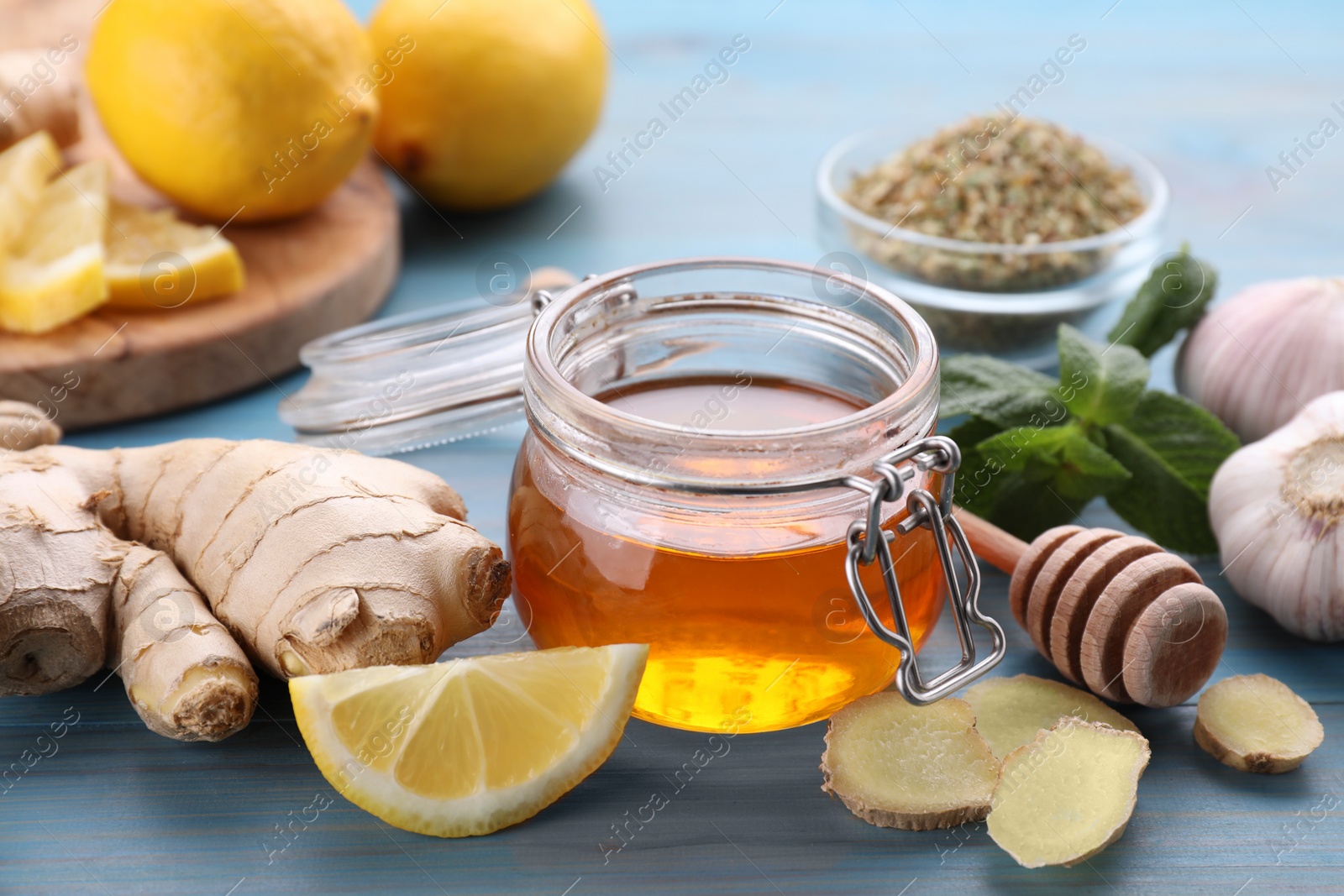 Photo of Cold remedies on light blue wooden table, closeup. Cough treatment