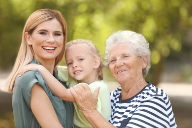 Woman with daughter and elderly mother outdoors