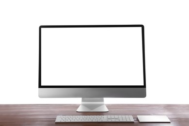 Modern computer with blank monitor screen and peripherals on wooden table against white background