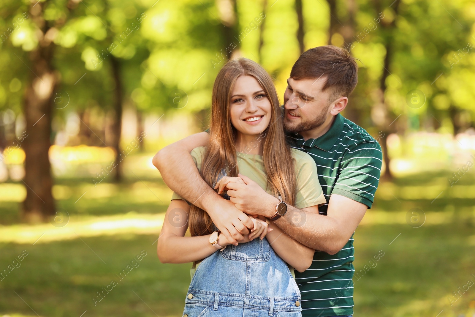 Photo of Happy young couple in green park on sunny spring day