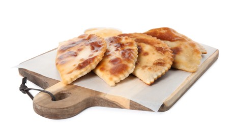 Photo of Delicious fried chebureki on wooden board against white background