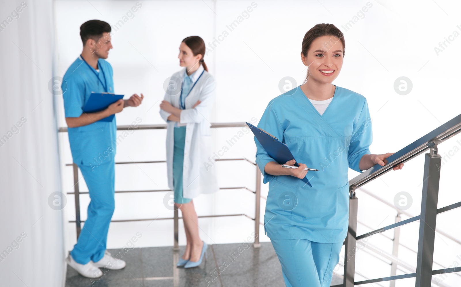 Photo of Female doctor going upstairs in modern clinic