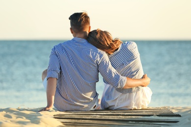 Photo of Happy young couple resting together on beach