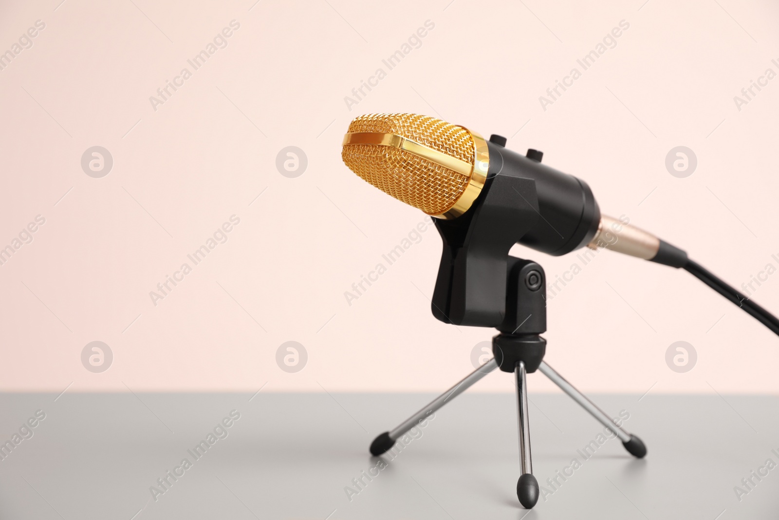 Photo of Microphone on light grey table, space for text. Journalist's work