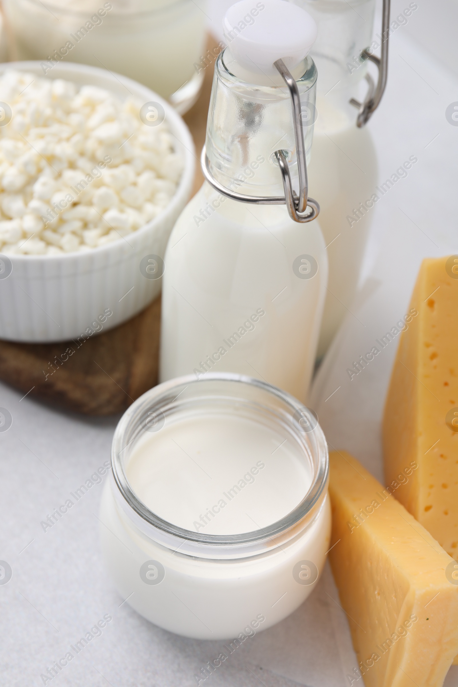 Photo of Different fresh dairy products on light table, closeup