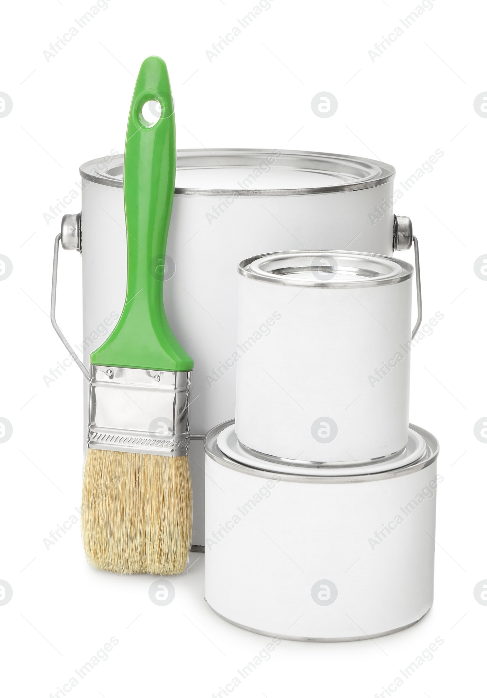 Photo of Closed blank cans of paint and brush on white background