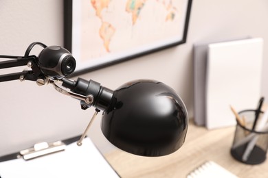 Photo of Hidden spy camera attached to table lamp indoors, closeup