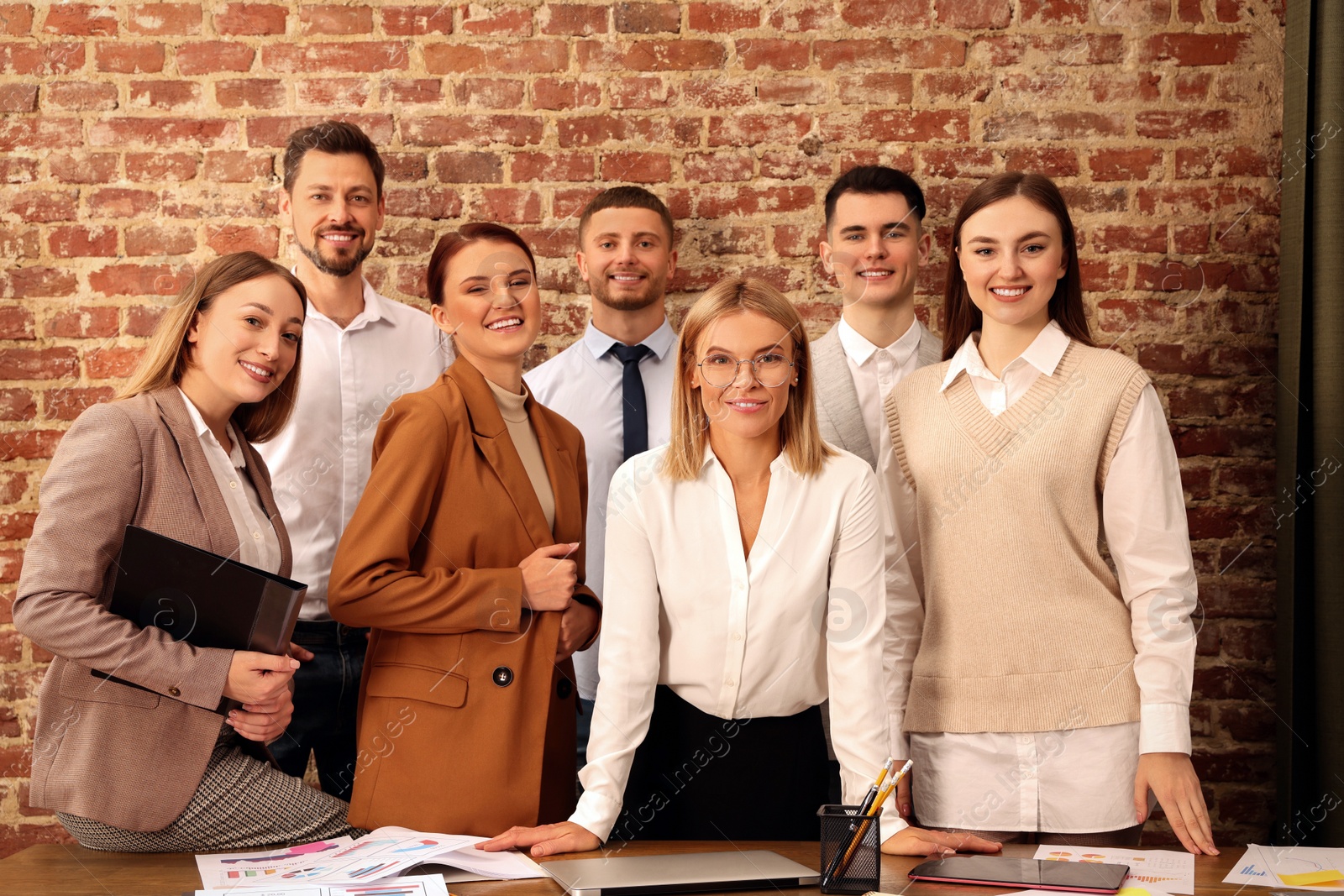 Photo of Businesswoman and her employees in office. Lady boss