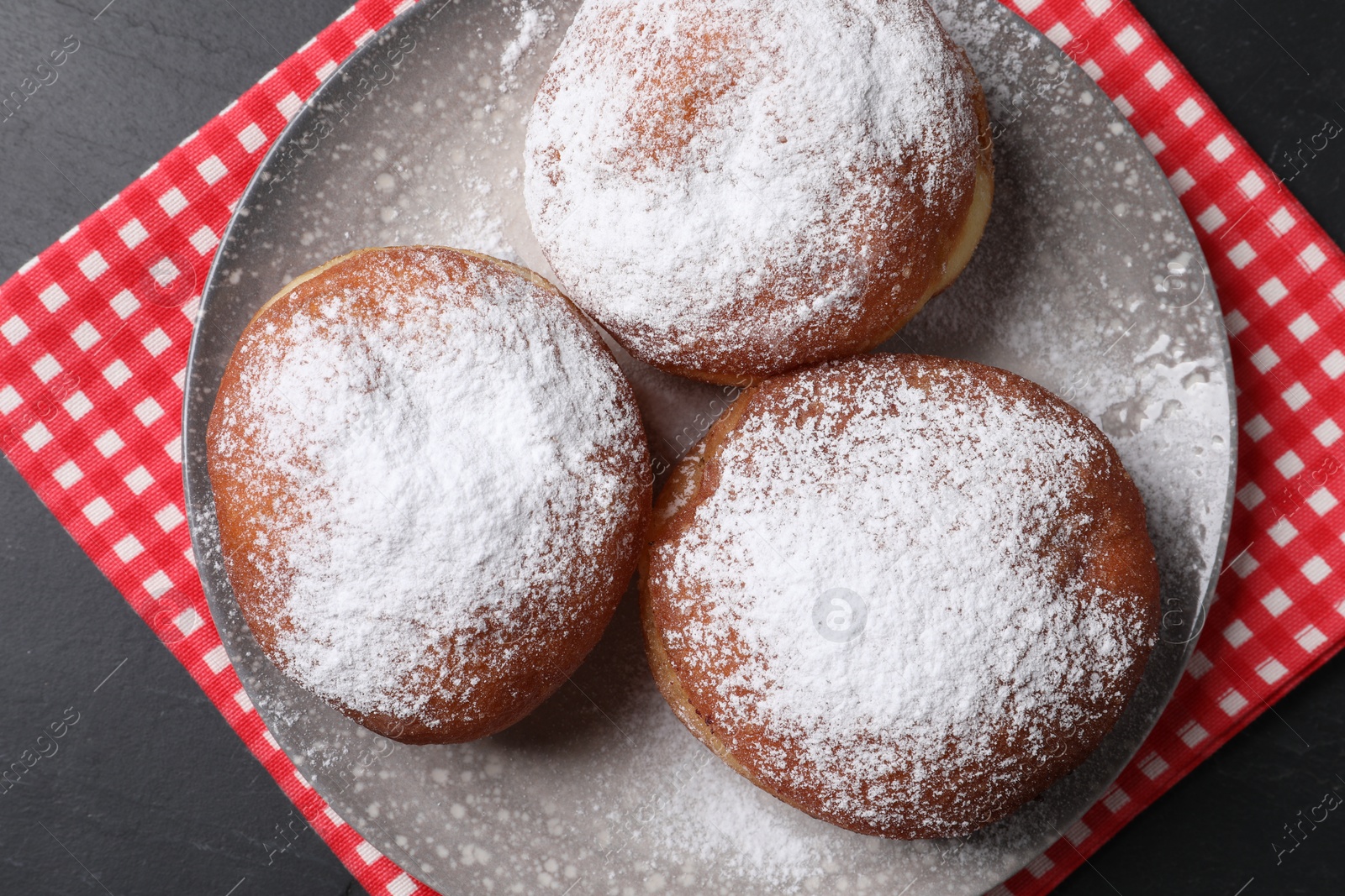 Photo of Delicious sweet buns with powdered sugar on table, top view
