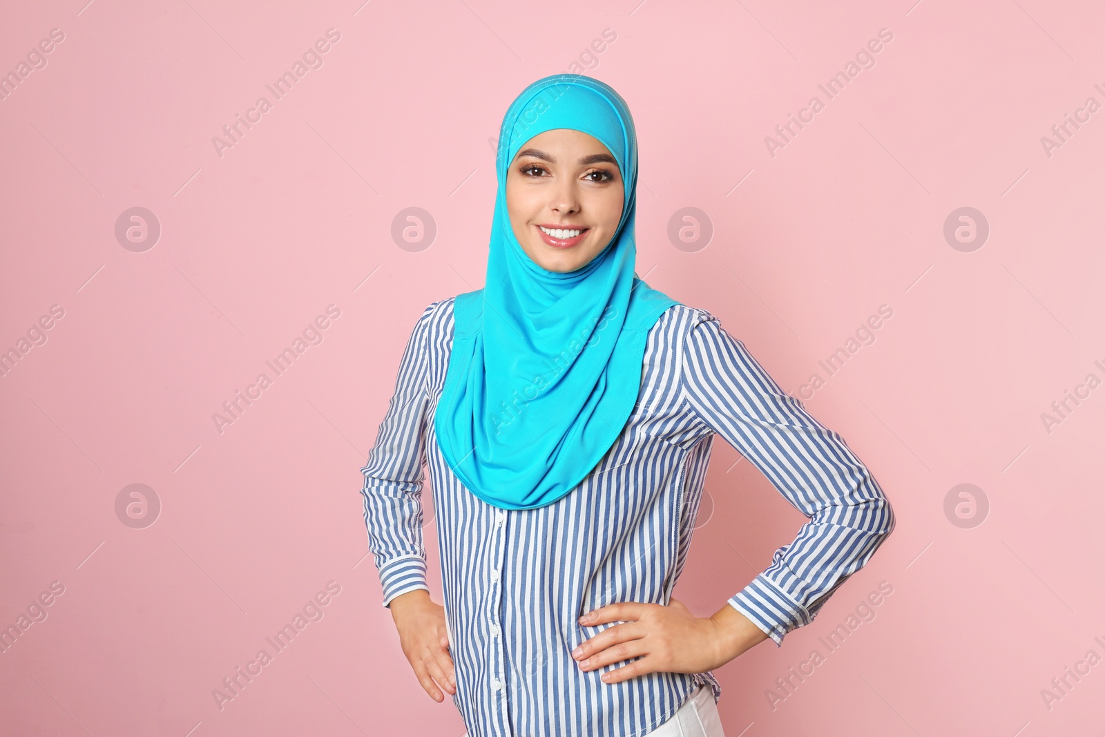 Photo of Portrait of young Muslim woman in hijab against color background