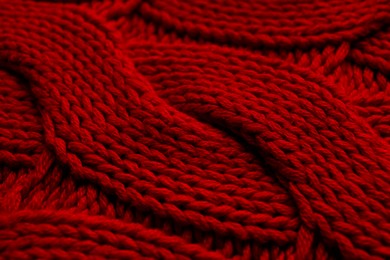 Photo of Beautiful red knitted fabric as background, closeup