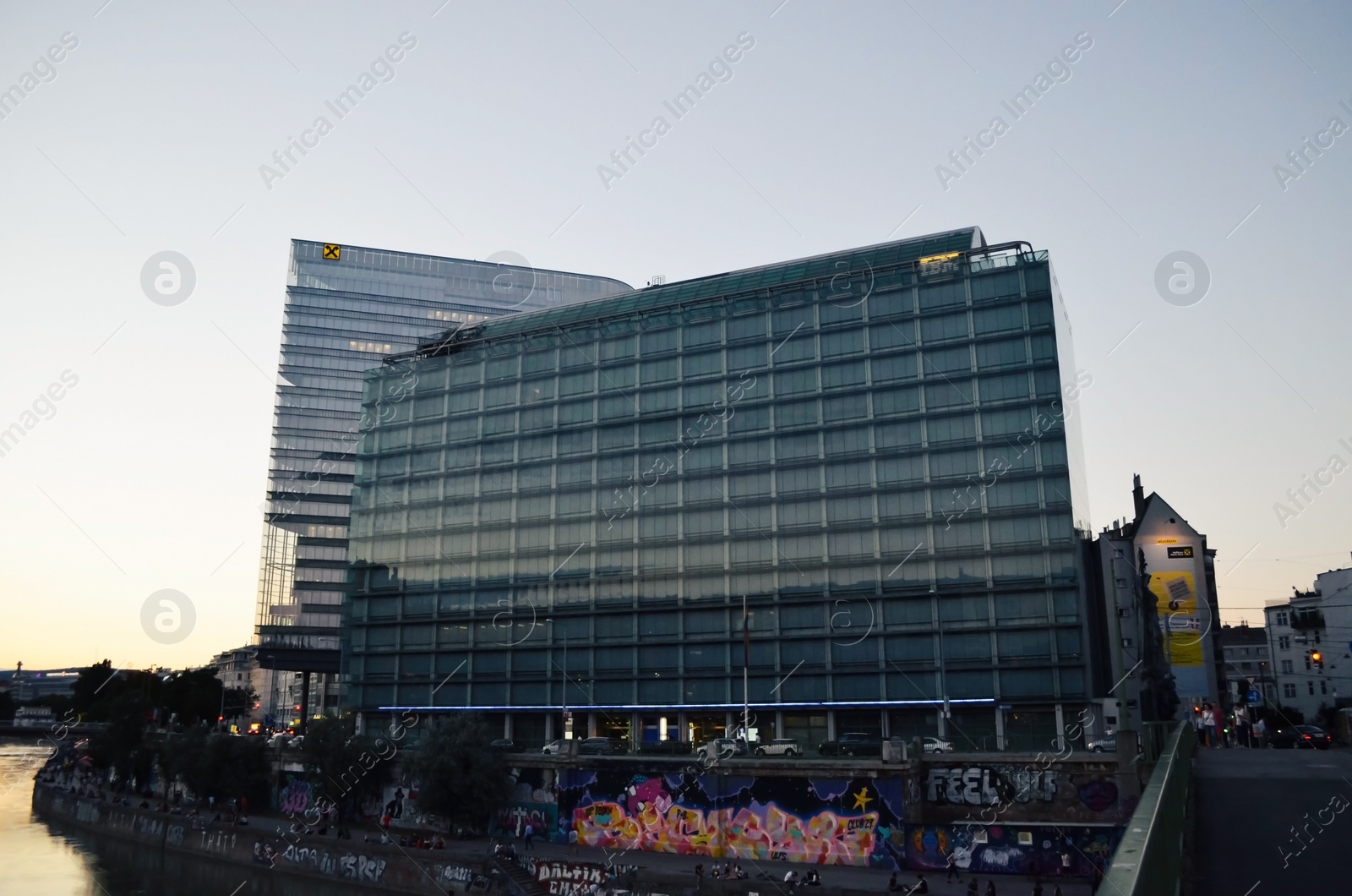 Photo of Vienna, Austria - June 20, 2018: Buildings of IBM and Raiffeisen companies near river