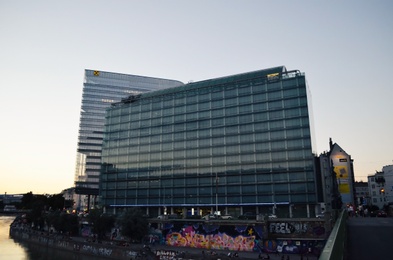 Photo of Vienna, Austria - June 20, 2018: Buildings of IBM and Raiffeisen companies near river