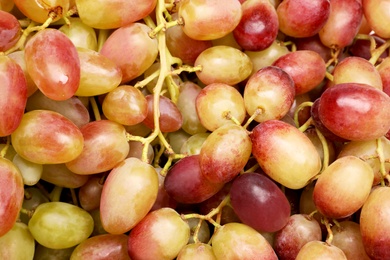Photo of Fresh ripe juicy grapes as background, top view