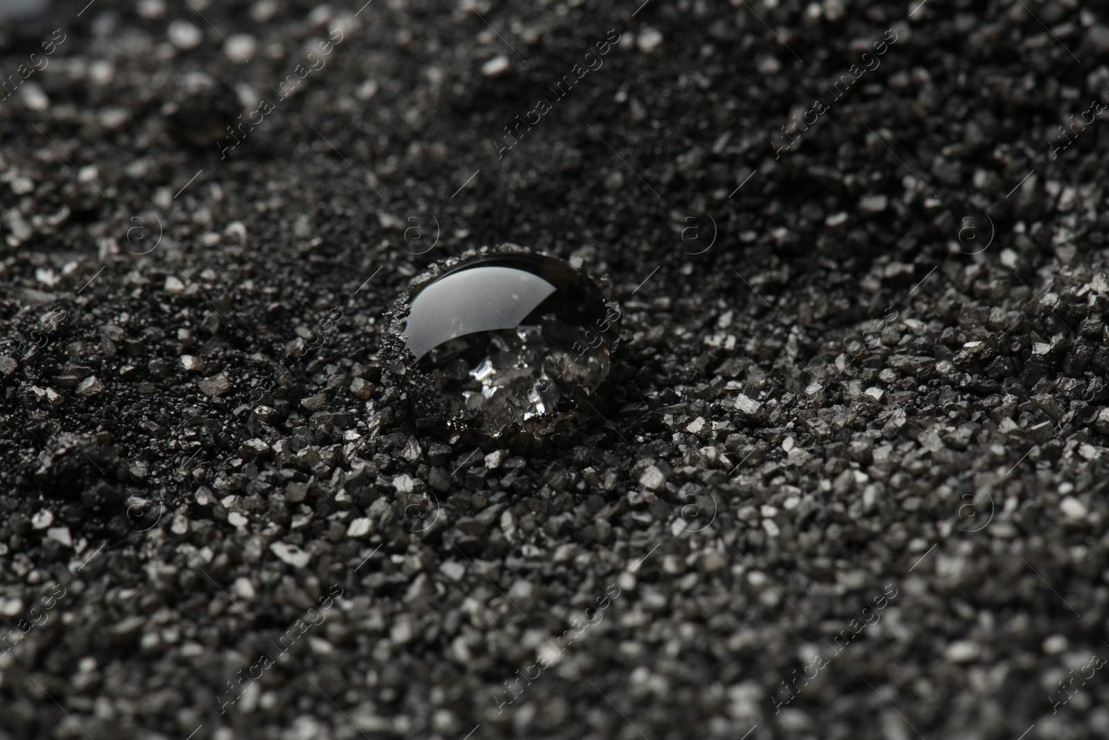 Photo of Beautiful gemstone for jewelry on decorative black sand