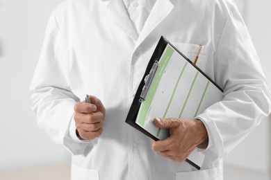 Doctor with patient's medical card in clinic, closeup