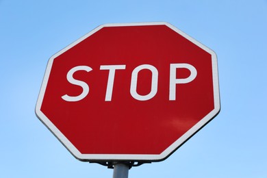 Photo of Traffic sign Stop against blue sky, low angle view