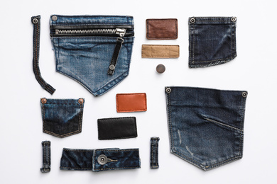 Photo of Composition with garment accessories and cutting details for jeans isolated on white, top view