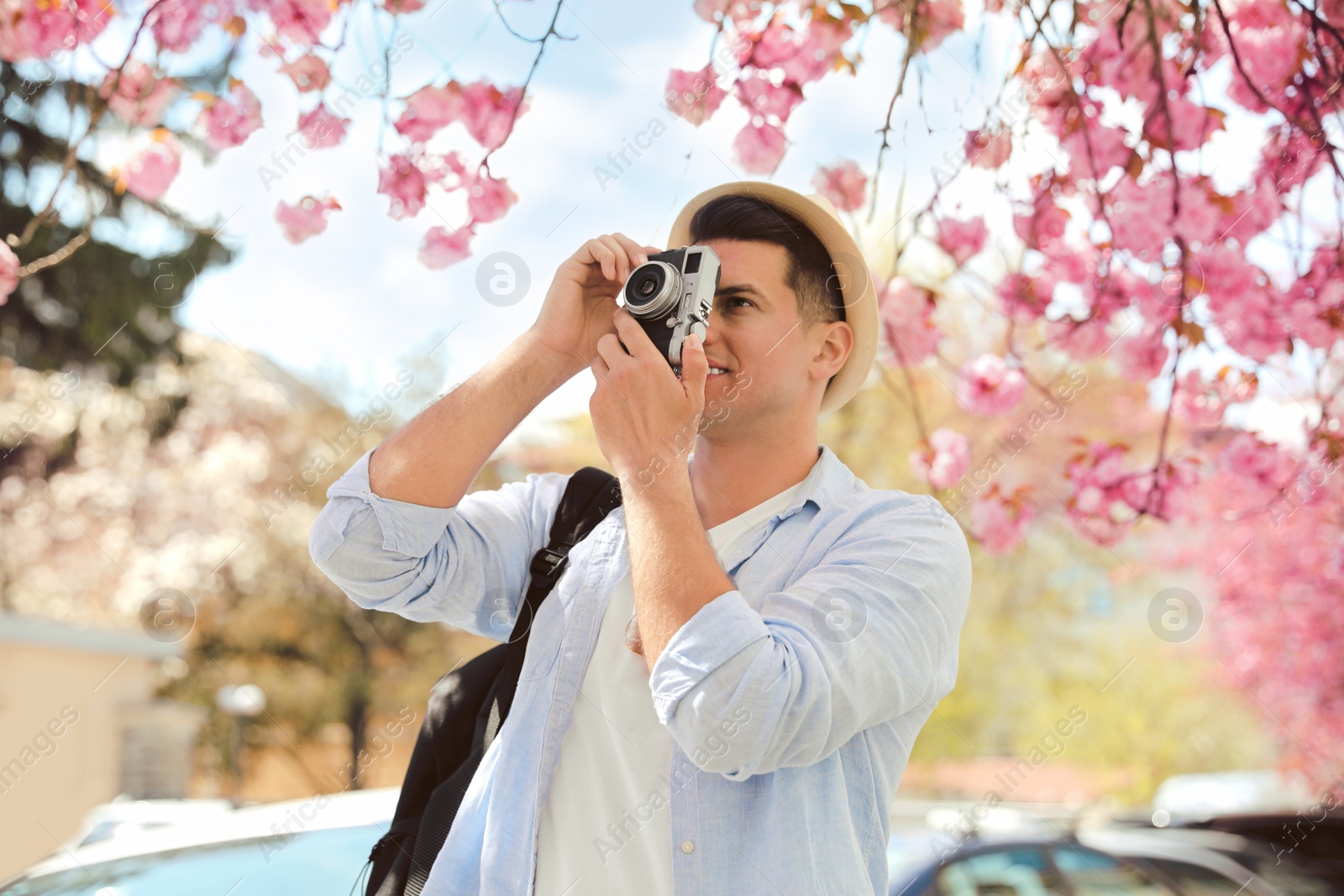 Photo of Tourist taking picture on beautiful city street