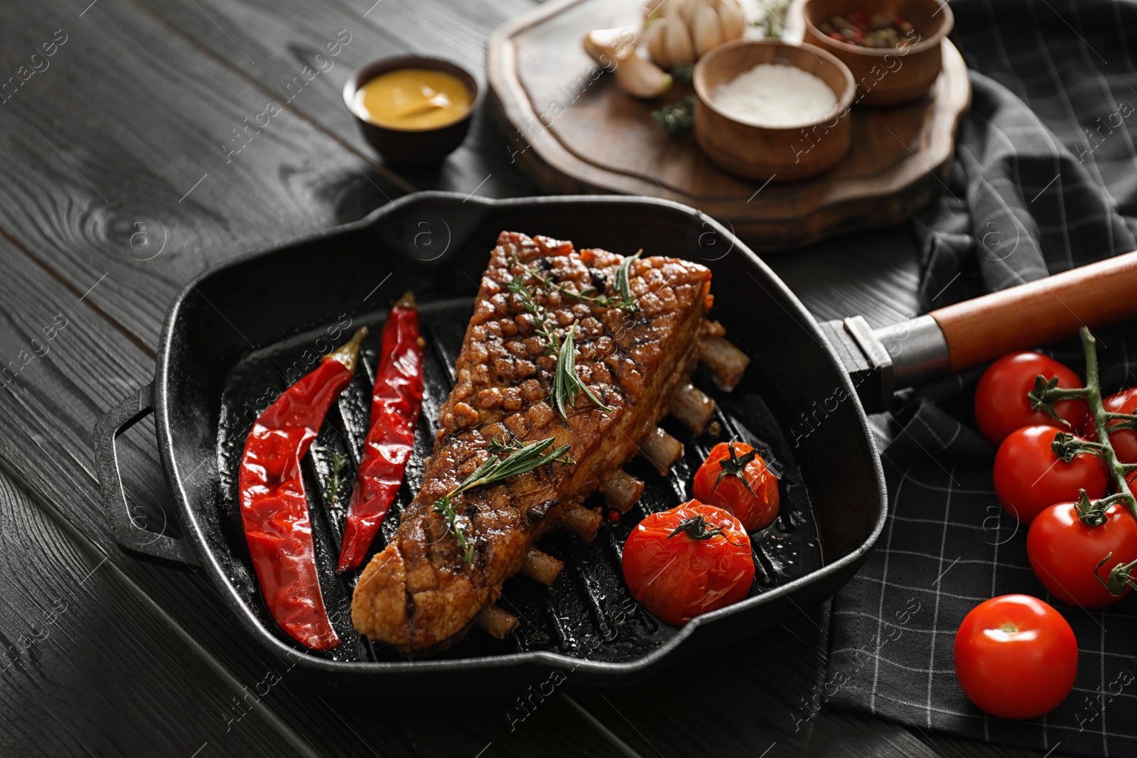 Photo of Delicious roasted ribs served on wooden table