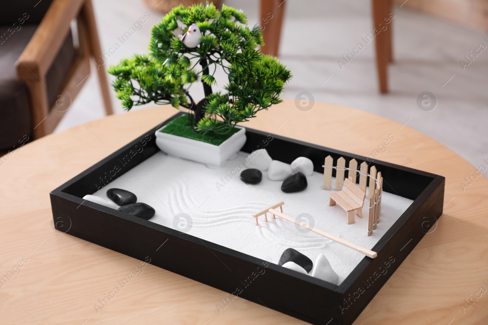 Photo of Beautiful miniature zen garden on wooden table indoors