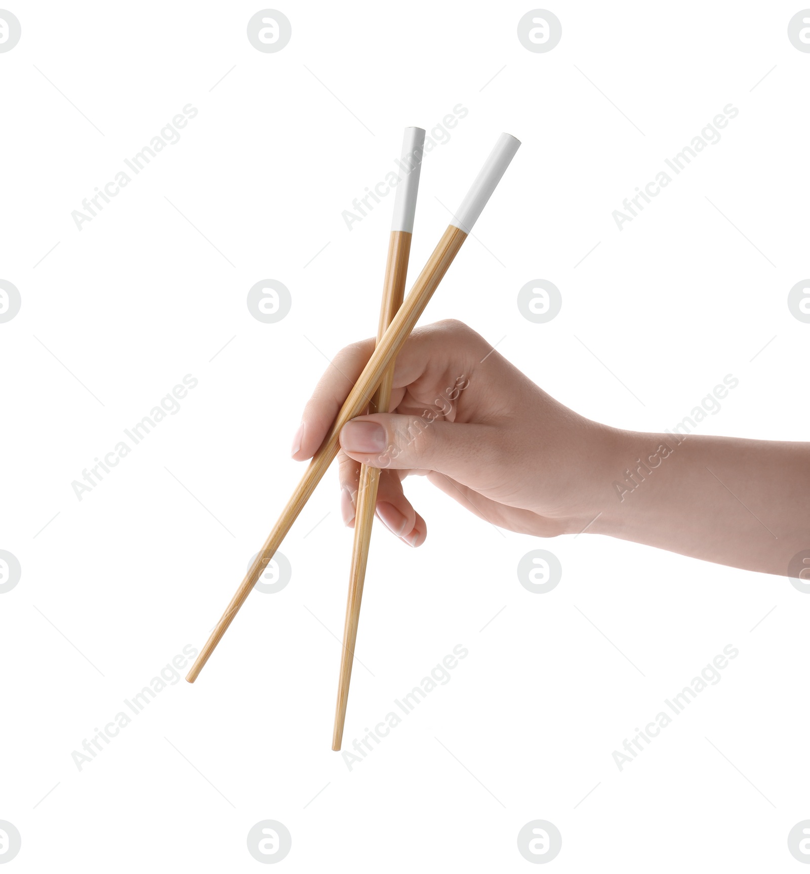 Photo of Woman holding pair of wooden chopsticks on white background, closeup