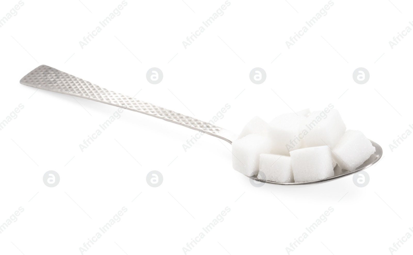 Photo of Sugar cubes in metal spoon isolated on white