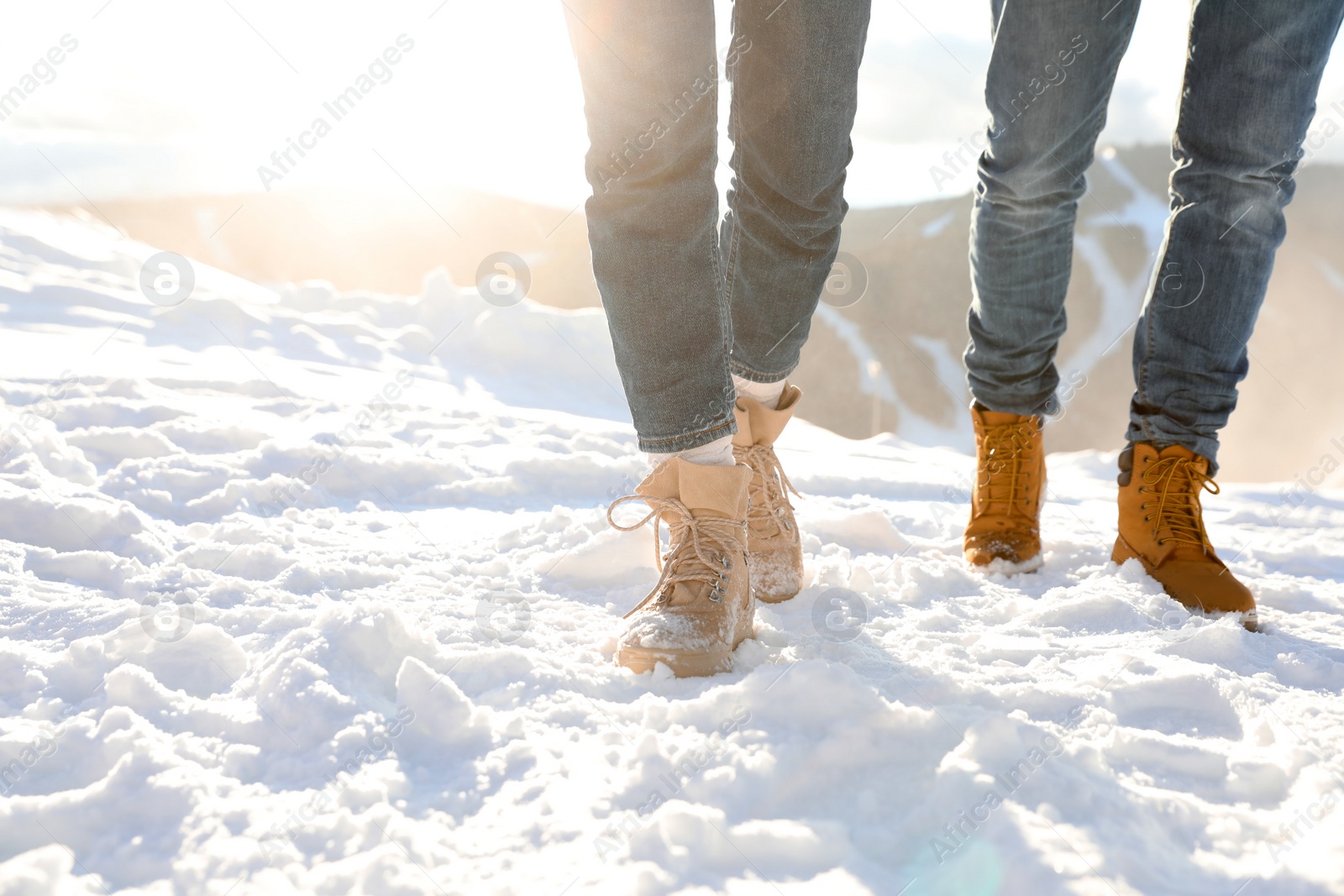 Photo of Couple walking on sunny winter day after snow storm