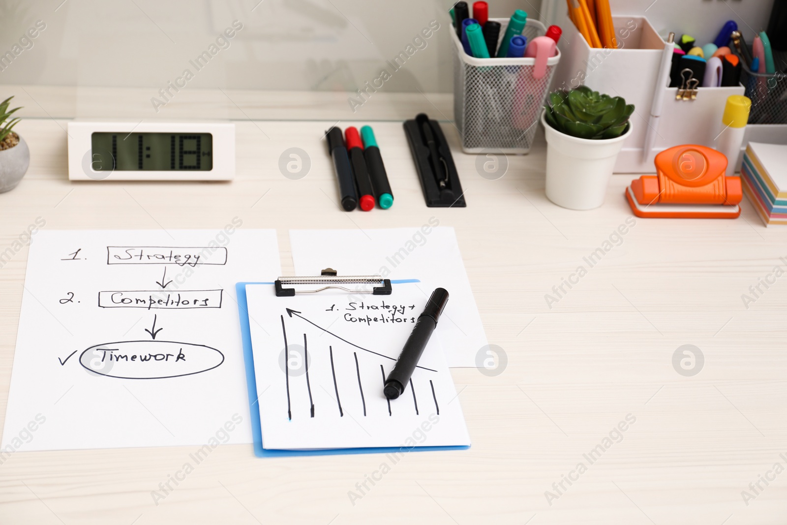 Photo of Business process planning and optimization. Workplace with plan, notebook and stationery on white wooden table