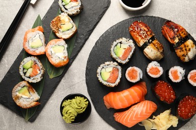 Photo of Flat lay composition with delicious sushi rolls on light grey table