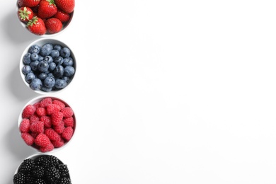 Photo of Bowls with raspberries and different berries on white background