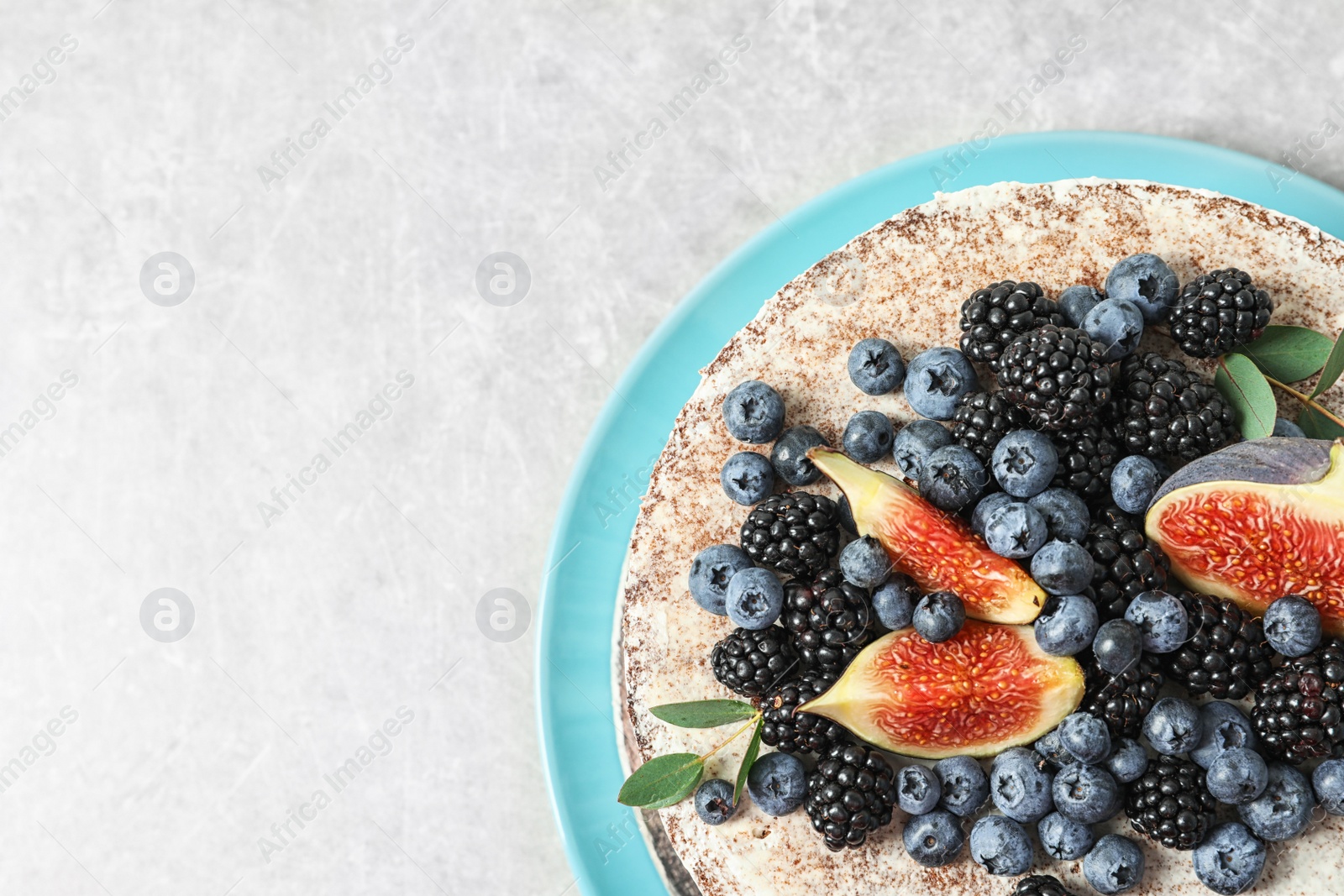 Photo of Delicious homemade cake with fresh berries and space for text on table, top view