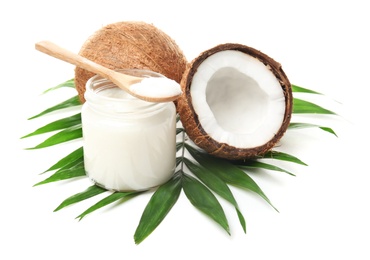 Jar with coconut oil and nuts on white background