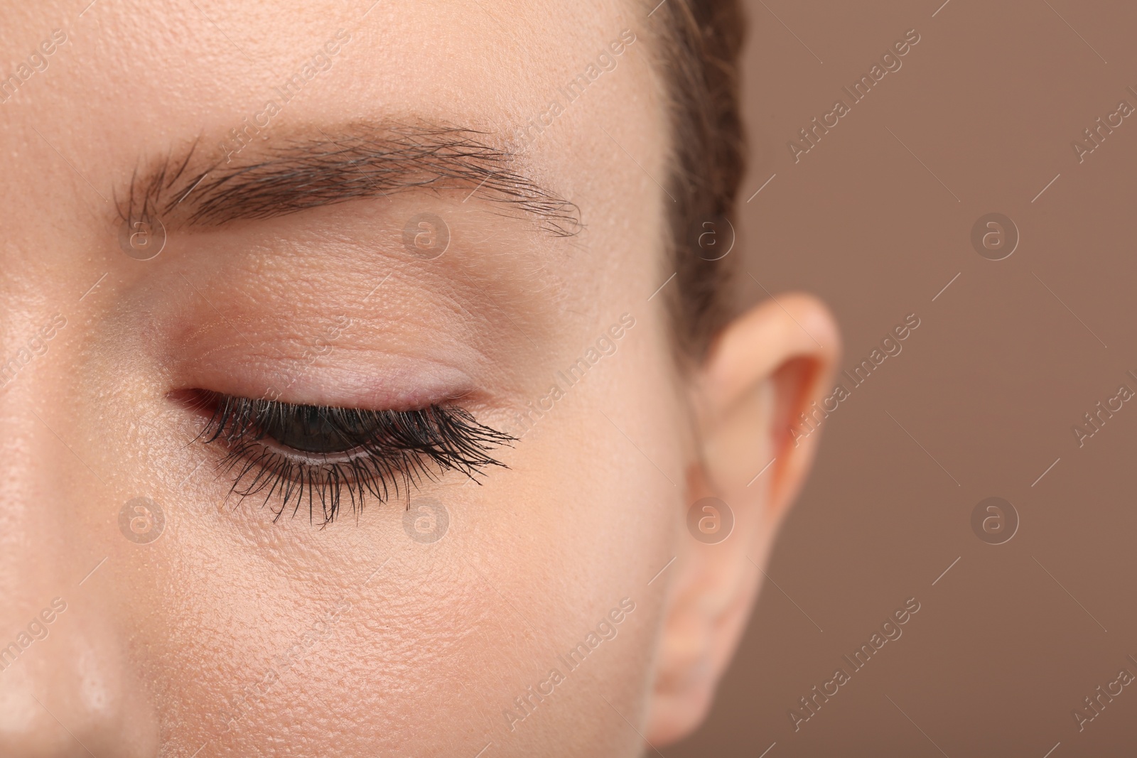 Photo of Woman with long eyelashes after mascara applying, closeup