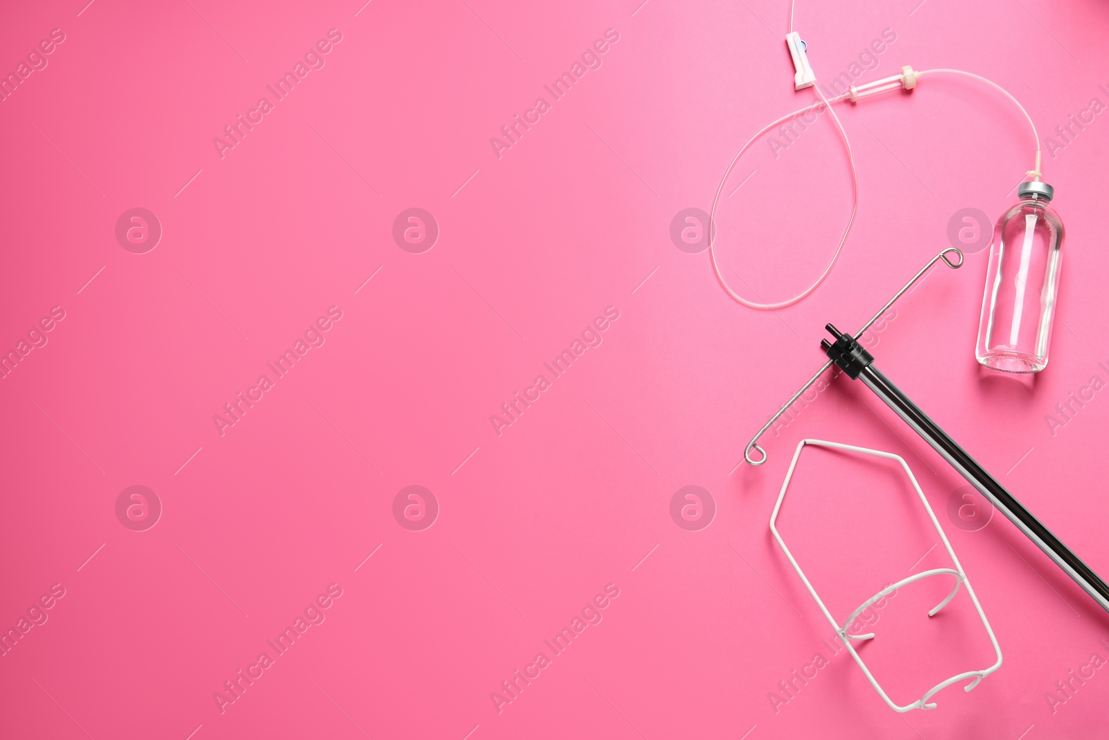 Photo of IV infusion set on pink background, flat lay. Space for text