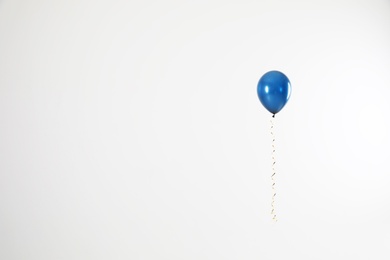 Photo of Bright balloon on light background, space for text. Celebration time