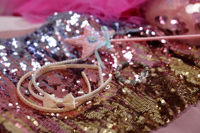 Photo of Stylish carnival costume with sequins, wand and headbands, closeup