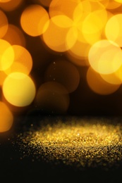 Gold glitter with bokeh effect on black background