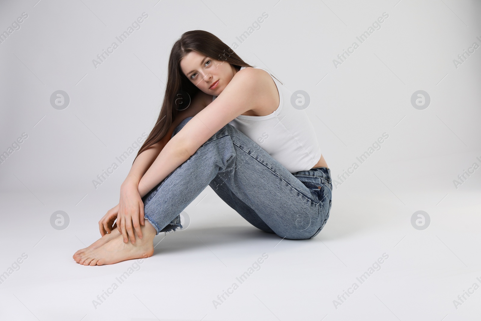 Photo of Portrait of beautiful young woman on light grey background