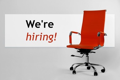 Image of We`re hiring! Red office chair on light grey background