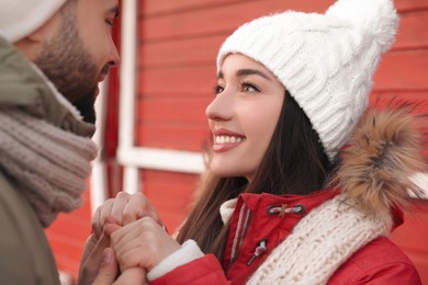 Photo of Happy young couple spending time together at winter fair. Christmas celebration