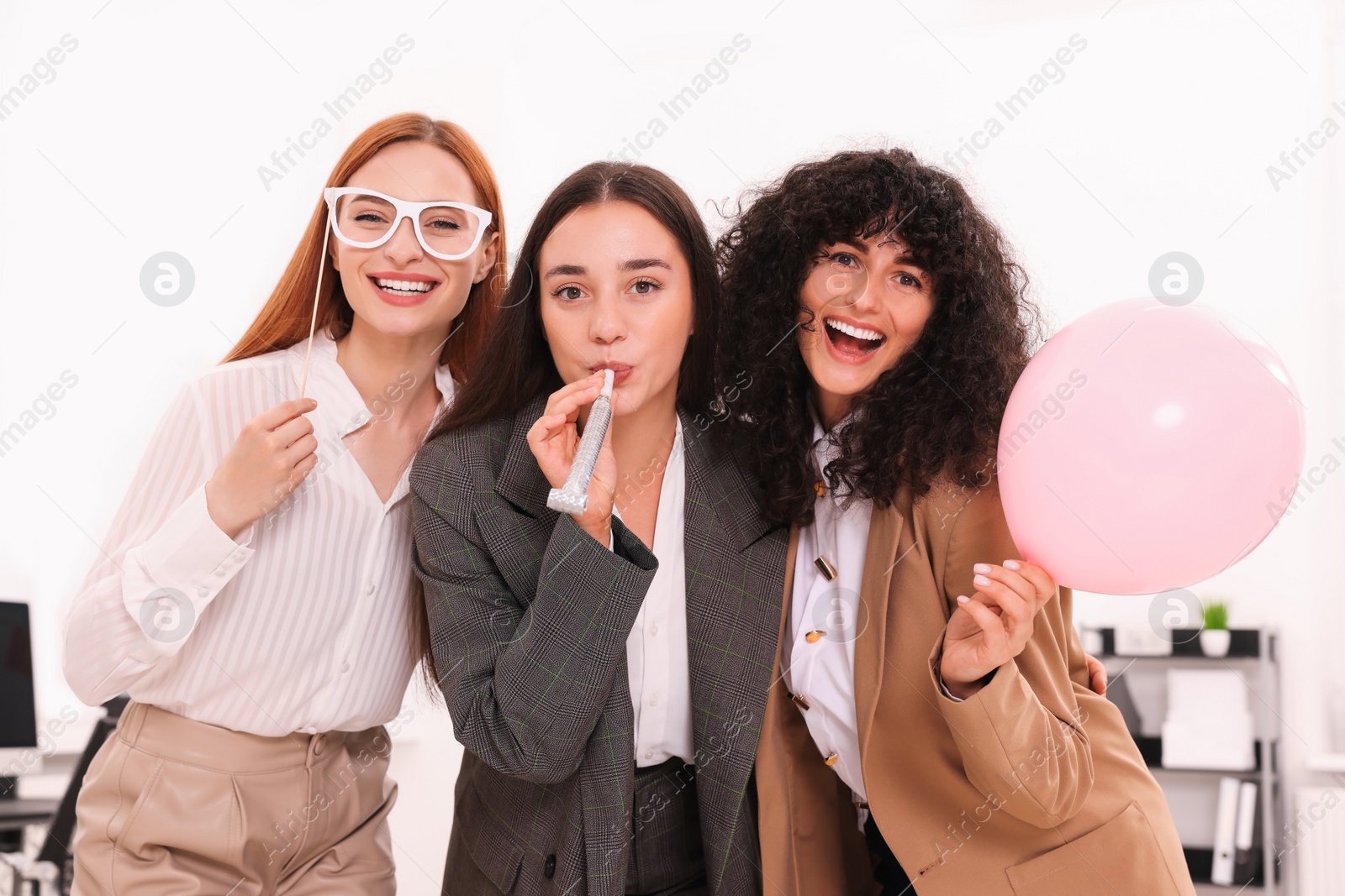 Photo of Coworkers having fun during office party indoors