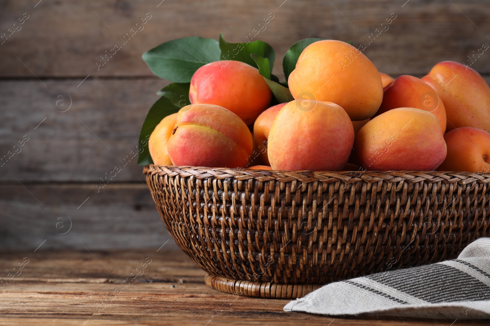 Photo of Delicious fresh ripe apricots on wooden table