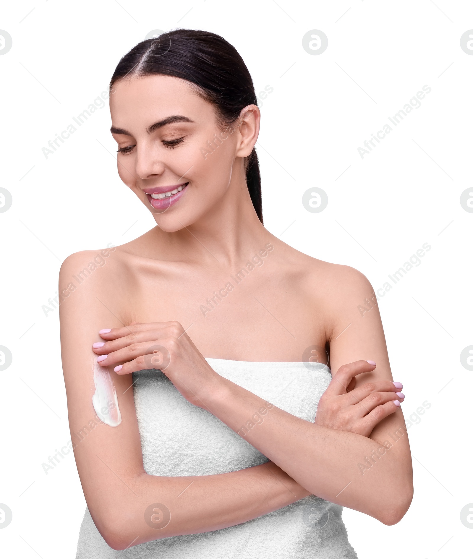 Photo of Beautiful woman with smear of body cream on her arm against white background