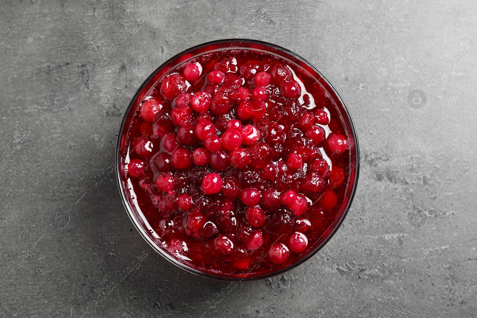 Photo of Fresh cranberry sauce on grey table, top view