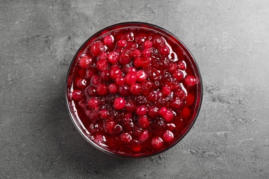 Fresh cranberry sauce on grey table, top view