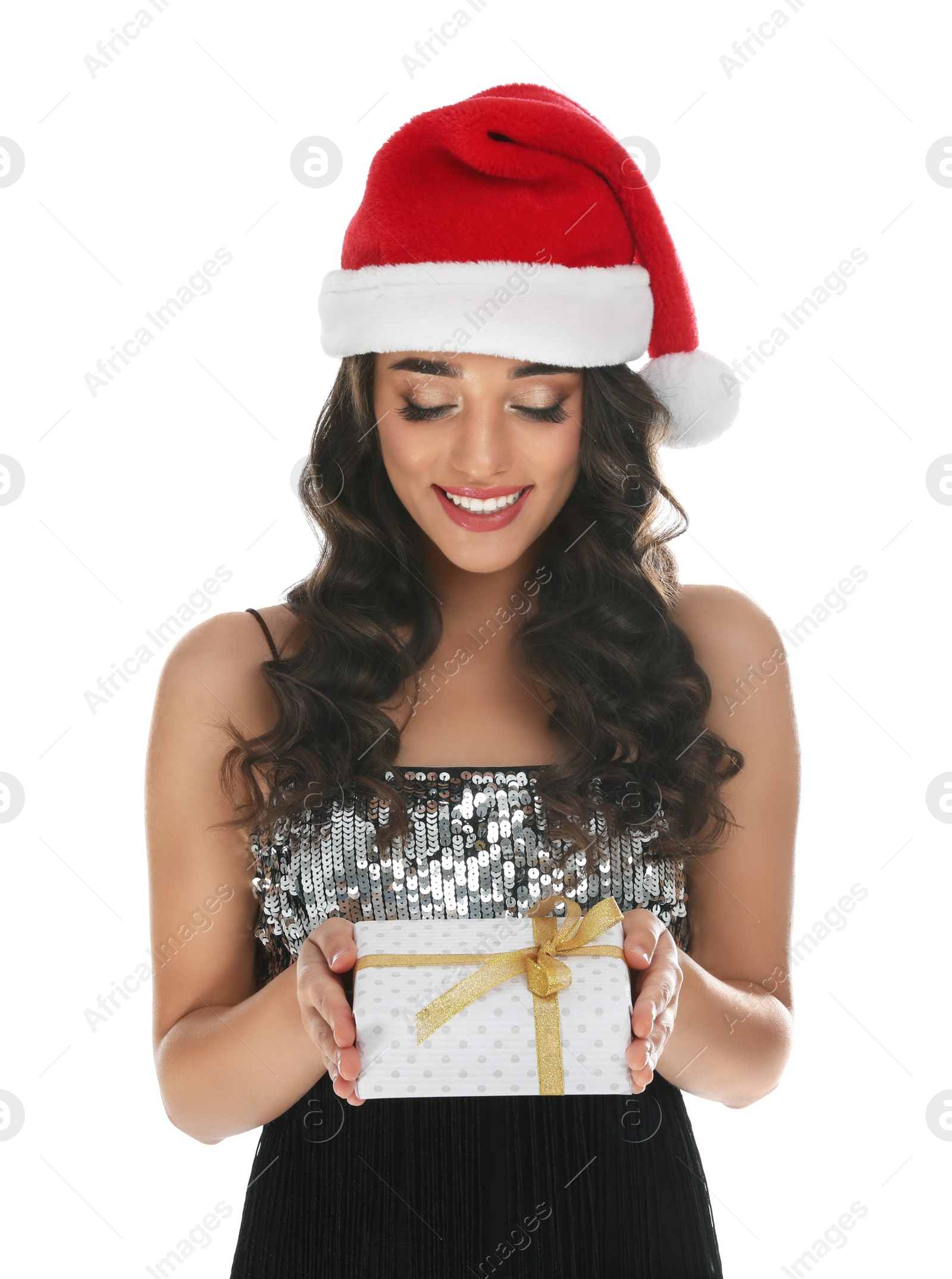 Photo of Beautiful woman in Santa hat with Christmas gift on white background