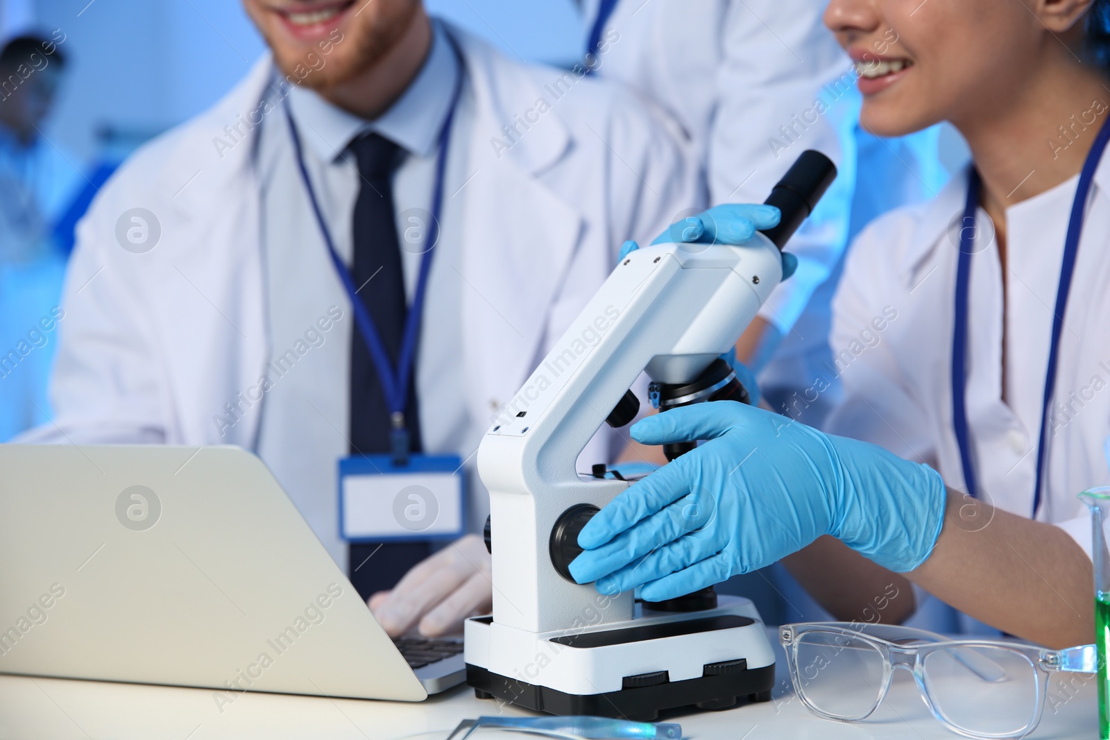 Photo of Scientists working in modern chemistry laboratory, closeup